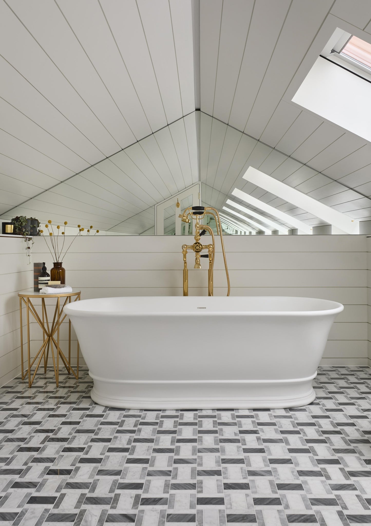 White freestanding bathtub by BC Designs, Bampton 1555mm model, with smooth curved edges and a sleek matte finish.